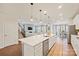 Bright, open kitchen with an island bar, stainless steel appliances, and adjacent living area at 22014 Finworthy Ln, Huntersville, NC 28078