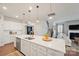 Open concept kitchen showcasing a large island, modern pendant lighting, and ample cabinet space at 22014 Finworthy Ln, Huntersville, NC 28078
