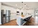 Contemporary kitchen featuring a large island, sleek stainless steel appliances, and hardwood floors at 22014 Finworthy Ln, Huntersville, NC 28078