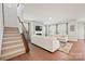 Bright living room with hardwood floors, staircase, and fireplace at 22014 Finworthy Ln, Huntersville, NC 28078