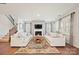 Bright living room featuring hardwood floors, a fireplace, and staircase to the second floor at 22014 Finworthy Ln, Huntersville, NC 28078