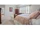 Another view of a main bedroom featuring a seating area, and large windows with curtains at 22014 Finworthy Ln, Huntersville, NC 28078