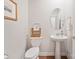 Cozy powder room featuring a pedestal sink, and decorative mirror and fixtures at 22014 Finworthy Ln, Huntersville, NC 28078