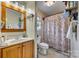 Full bath with a wooden framed mirror and floral shower curtain at 2331 Gill Jordan Rd, Chester, SC 29706