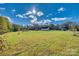 Expansive yard with lush greenery, trees, and a charming house in the background at 2331 Gill Jordan Rd, Chester, SC 29706