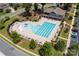 Aerial view of the community pool with sun loungers, umbrellas, landscaping, and clubhouse at 246 Sweet Briar Dr, Fort Mill, SC 29707
