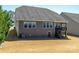 The backyard features a well-maintained lawn, windows, stairs to a deck, and easy access to the home's exterior at 246 Sweet Briar Dr, Fort Mill, SC 29707