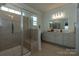 Bright bathroom features a glass-enclosed shower, vanity with mirror, and ample counter space at 246 Sweet Briar Dr, Fort Mill, SC 29707