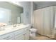 Bright bathroom with a white vanity, toilet, and striped shower curtain providing a clean and functional space at 246 Sweet Briar Dr, Fort Mill, SC 29707