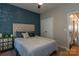Serene bedroom featuring a tufted headboard, decorative accent wall, and natural light at 246 Sweet Briar Dr, Fort Mill, SC 29707