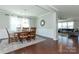Open-concept dining area showcases a stylish chandelier, decorative mirror, and access to the living room at 246 Sweet Briar Dr, Fort Mill, SC 29707