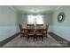 Bright dining room featuring a wooden table, six chairs, elegant chandelier, and large windows with sheer curtains at 246 Sweet Briar Dr, Fort Mill, SC 29707