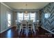 Stylish dining room with a wood table, patterned chairs, a modern chandelier, and a distinctive accent wall at 246 Sweet Briar Dr, Fort Mill, SC 29707