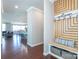 Inviting entryway with wood floors and custom drop zone with bench, storage, and welcome sign at 246 Sweet Briar Dr, Fort Mill, SC 29707
