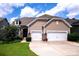 Charming home featuring a two-car garage, stone accents, shake siding, and manicured lawn with lush greenery at 246 Sweet Briar Dr, Fort Mill, SC 29707