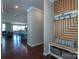 Foyer with wood floors and decorative storage leading into an open-concept living space with dining and kitchen areas at 246 Sweet Briar Dr, Fort Mill, SC 29707