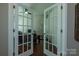 Home office with a view through glass panel french doors featuring a ceiling fan and hardwood floors at 246 Sweet Briar Dr, Fort Mill, SC 29707