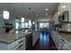 Open-concept kitchen featuring granite countertops, stainless steel appliances, and a seamless view of the living and dining areas at 246 Sweet Briar Dr, Fort Mill, SC 29707
