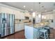 Bright kitchen with stainless steel refrigerator, island with seating, and granite countertops at 246 Sweet Briar Dr, Fort Mill, SC 29707