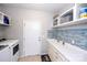 Well-equipped laundry room featuring modern appliances, ample counter space, and stylish backsplash at 246 Sweet Briar Dr, Fort Mill, SC 29707