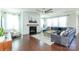 Bright living room with hardwood floors, stacked stone fireplace, and comfortable seating area at 246 Sweet Briar Dr, Fort Mill, SC 29707