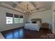 Elegant bedroom with tray ceiling, chandelier, and large windows for natural light at 246 Sweet Briar Dr, Fort Mill, SC 29707