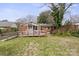 Rear exterior view of the brick house with a back deck and ramp to the lawn at 2922 Dunlavin Way, Charlotte, NC 28205