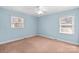 Bright bedroom with light blue walls, two windows, and neutral carpet at 2922 Dunlavin Way, Charlotte, NC 28205