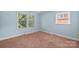 Bright bedroom with light blue walls, two windows, and neutral carpet at 2922 Dunlavin Way, Charlotte, NC 28205