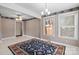 An open room is decorated with classic wallpaper with a chandelier, ceiling fan, and natural light at 2922 Dunlavin Way, Charlotte, NC 28205