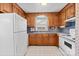 Well-appointed kitchen featuring wooden cabinets, classic appliances, and ample counter space at 2922 Dunlavin Way, Charlotte, NC 28205