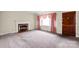 Spacious living room featuring a cozy fireplace, large window, and neutral carpet at 2922 Dunlavin Way, Charlotte, NC 28205