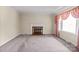Inviting living room featuring a cozy fireplace, large window, and neutral carpet at 2922 Dunlavin Way, Charlotte, NC 28205