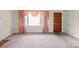 Bright living room featuring a cozy fireplace, large window, and neutral carpet at 2922 Dunlavin Way, Charlotte, NC 28205