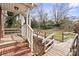 Accessible porch with white railings, brick steps, and wooden ramp to the landscaped yard at 2922 Dunlavin Way, Charlotte, NC 28205