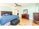 Bright bedroom featuring a large bed, hardwood floors, and a dresser with a mirror above at 3863 Shakespeare Dr, Hickory, NC 28601