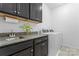 Laundry room with dark cabinetry, granite countertops, a sink, and a washer/dryer at 4315 Innisfree Ct, Indian Trail, NC 28079