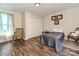 Bedroom featuring vinyl plank flooring, a gray bed, a closet, and two chairs with decor at 464 Willetta Nw Pl, Concord, NC 28027