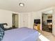 Bright bedroom with a blue bedspread, a chair, and easy access to closet and other rooms at 464 Willetta Nw Pl, Concord, NC 28027