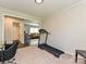 Spacious bonus room with a treadmill, neutral colors, and an open floor plan leading to other living spaces at 464 Willetta Nw Pl, Concord, NC 28027