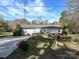Inviting home exterior with a well-kept yard and accessible ramp to the front door at 464 Willetta Nw Pl, Concord, NC 28027