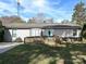 Ranch style home with a teal door, wheelchair ramp, and a well-maintained lawn at 464 Willetta Nw Pl, Concord, NC 28027