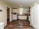 Bright kitchen with white cabinets, stainless steel appliances, and hardwood flooring at 464 Willetta Nw Pl, Concord, NC 28027