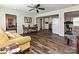 Cozy living room featuring hardwood floors, a ceiling fan, and seamlessly connects to the kitchen and bedroom at 464 Willetta Nw Pl, Concord, NC 28027