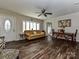 Inviting living room with hardwood floors, a yellow sofa, and a bay window providing natural light at 464 Willetta Nw Pl, Concord, NC 28027