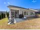 Covered patio with outdoor seating and grilling area overlooking the yard at 5013 Watercrest Trl, Belmont, NC 28012