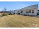 Large backyard with patio, lush lawn, and beautiful landscaping at 5013 Watercrest Trl, Belmont, NC 28012