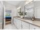 Bright bathroom featuring double sinks, white cabinets, marble floors, a glass shower, and a glimpse of the bedroom at 5013 Watercrest Trl, Belmont, NC 28012