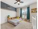 bedroom with carpet, a ceiling fan, and decoratively painted accent wall at 5013 Watercrest Trl, Belmont, NC 28012