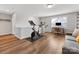 Bonus room featuring vinyl floors, an exercise bike, a desk and chair, and a gray couch at 5013 Watercrest Trl, Belmont, NC 28012